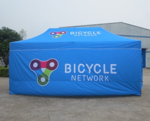 blue custom marquee with a bicycle network logo on it