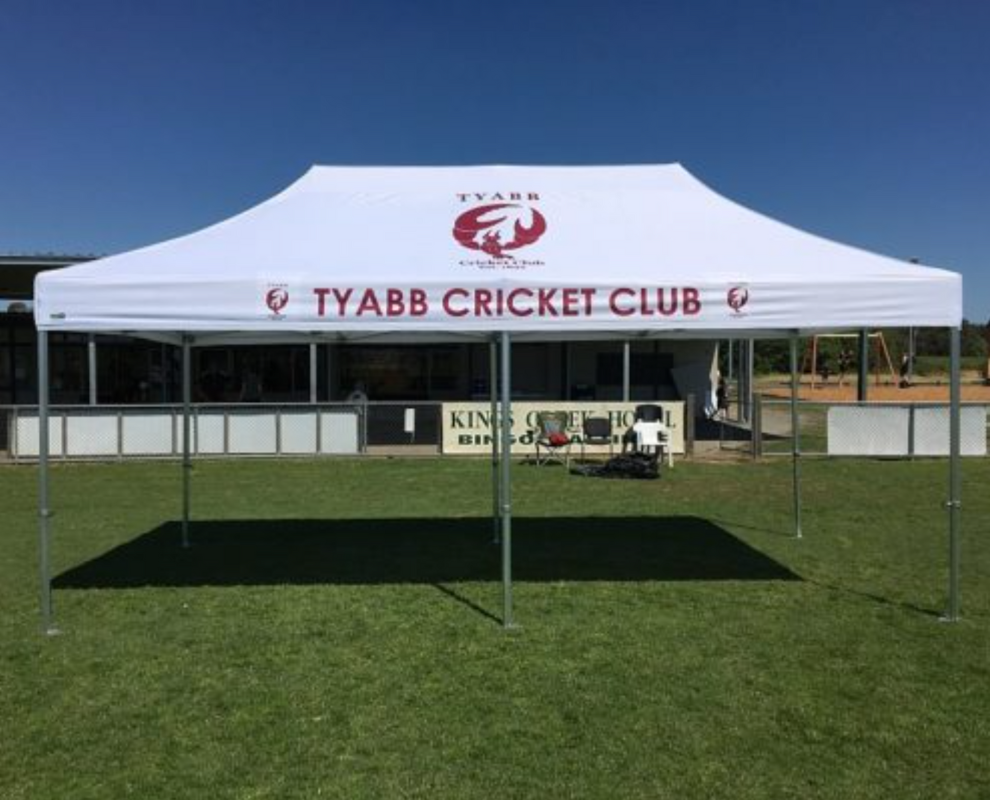 White custom cricket marquee wit red text and logo.